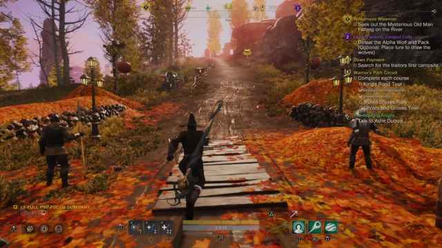 A player running out of the western gate of Oxboro Village, passing two NPCs along the way, with autumn-themed scenery.